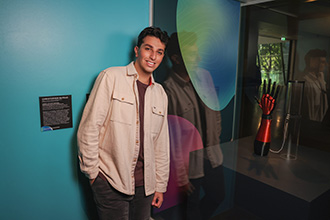 A a man standing in front of an exhibit